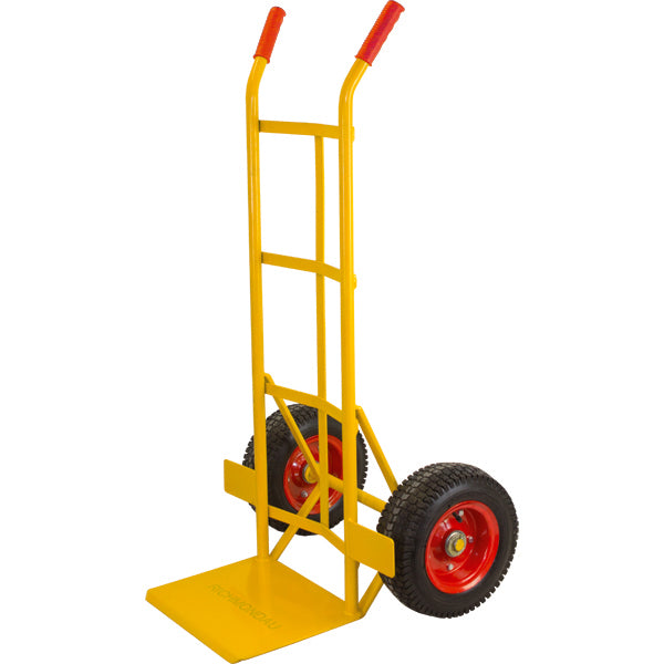 A yellow metal hand truck with a flat platform, two black rubber wheels with red rims, and red handle grips, shown on a plain white background.